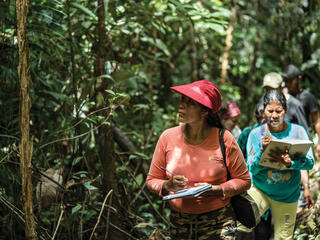 Women walking through forest