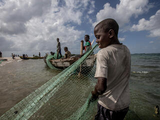 Fisherman gathers seine nets from the water on the Ilha de Mafamede, Mozambique. Mafamede is one of the protected islands that comprise Primeiras e Segundas.