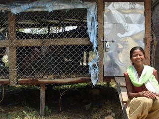 Woman in front of pen of goats in Khata corridor, Nepal