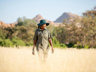  Rhino ranger Erlyn Touros looks for rhino tracks in the Uibasen Twyfelfontein Conservancy, Namibia