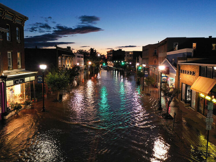 a flooded city street at sunset