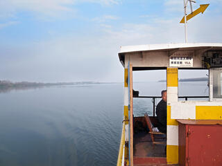 A ferry captain looks for signs of the Yangtze finless porpoise on the Tian-E-Zhou oxbow lake near Yueyang, China