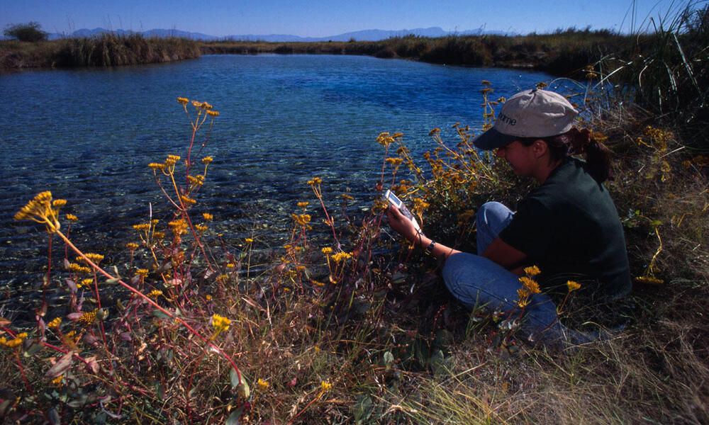 A scientist testing wetland pools to monitor changes in pH Cuatrocienigas Chihuahua Desert, Mexico