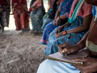 Closeup of hands taking notes