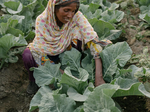 Crouching woman in garden