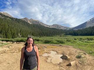 Paulson standing in front of mountains