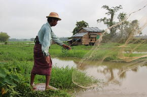 A man throws a fishing net in Myanmar