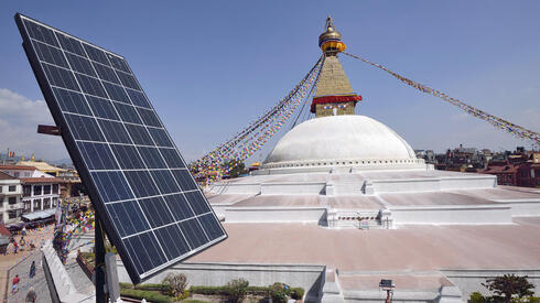 Solar panel on a roof top over looking a Buddhist shrine, Bodhnath Stupa in Kathmandu, Nepal