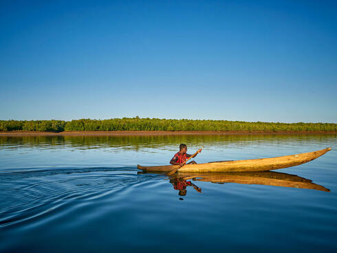 Lone fisher sets off in boat on coast of Madagascar