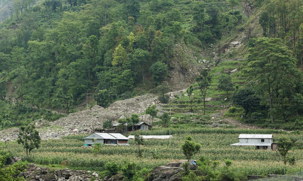 A large sloping hill with a village at the bottom